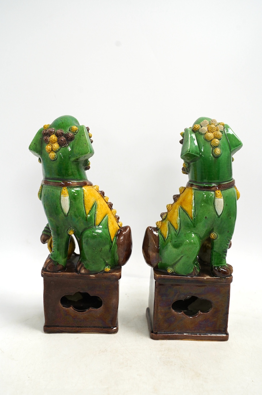 A pair of Chinese lion dogs and a floral enamelled jar and cover, largest 26cm high. Condition - good
